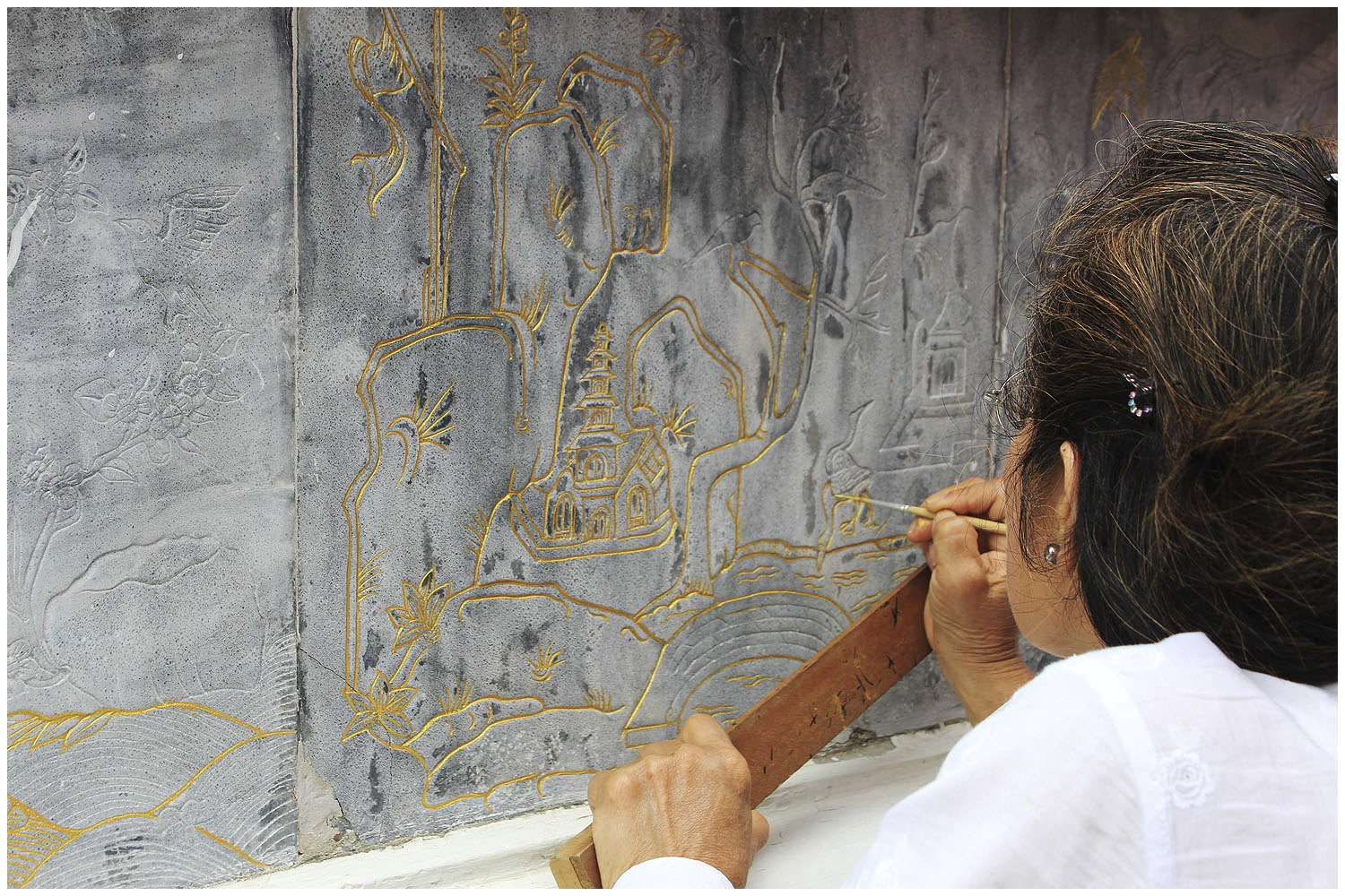 Woman restoring artwork at Wat Pho Bangkok