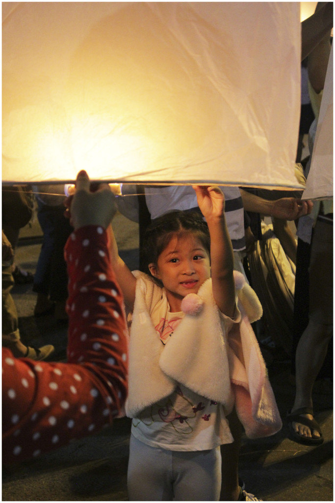 Little girl releasing her krathong